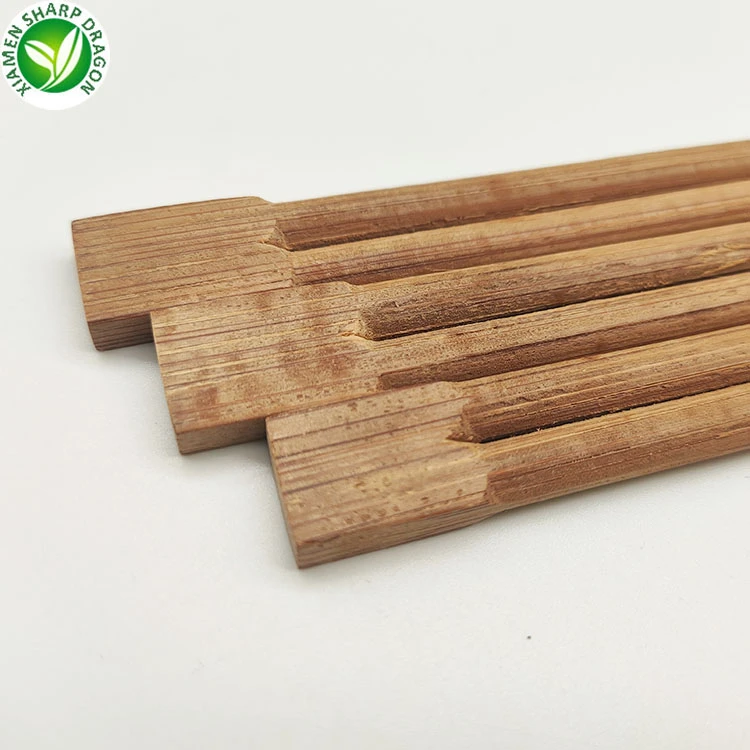 Broad joined ends of bamboo-colored chopstick pairs Broad joined ends of bamboo-colored chopstick pairs